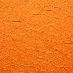 Fototapeta premium Macro studio shot of textured orange handmade paper with deep wrinkles and organic creases. Detailed close-up of an embossed fibrous surface for background and graphic design use.