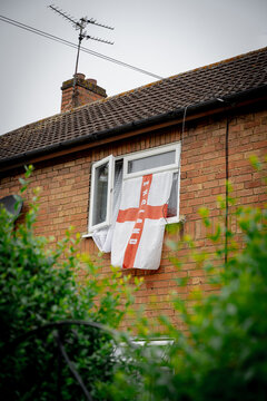 Corby, Northamptonshire, United Kingdom - July 15, 2026: England flag hanging from house window in residential neighborhood