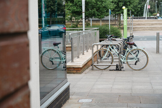Corby, Northamptonshire, United Kingdom - July 15, 2026: Bicycles parked at modern bike rack in urban city center