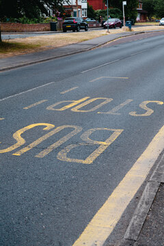 Corby, Northamptonshire, United Kingdom - July 15, 2026: Bus stop road marking on suburban street in the United Kingdom