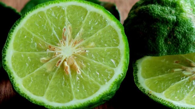 Fresh Kaffir Lime Halves on Wooden Cutting Board