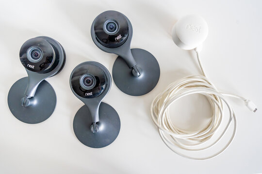 Prague, Czech Republic - June 30, 2026: Nest security cameras and a Nest outdoor camera cable are arranged on a white surface. Smart home security ecosystem concept for surveillance, monitoring 