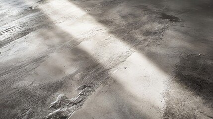 Fototapeta premium Sunlit, textured concrete floor.
