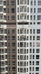 Full frame symmetric view of high-rise residential apartment windows in Jakarta City © Said