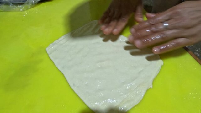 Special Moroccan pancakes called "Msemen" being prepared. These delicious, flaky, and layered pancakes are a staple of Moroccan cuisine and are made by folding the dough to create multiple layers