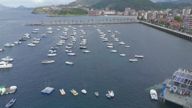 Drone flying over boats in castro urdiales harbor