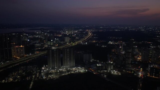 Aerial night view of Kokapet with nanakramguda, financial district and outer ring at hyderabad, telangana, india. night time, trucking shot, drone shot, 4k.