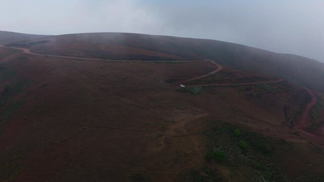 Chandra Drona Parvatha with fog and Bababudan Giri mud Road at Nagenahalli, Dattathreyapeeta, Chikkamagaluru, Karnataka, india. day time, push in shot, drone shot, 4k.