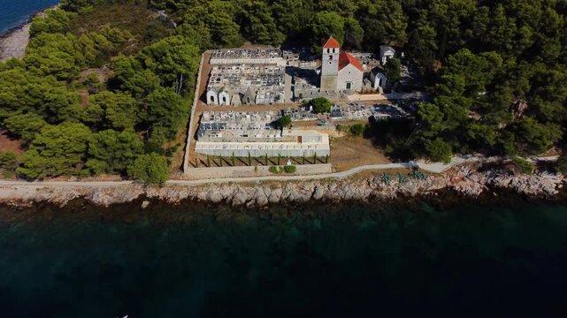 Aerial view of jelsa cemetery and church on hvar island, croatia