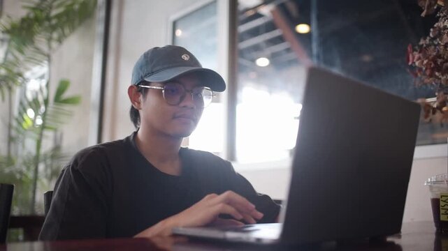 Freelance professional utilizing laptop computer within modern workspace for business network communication and strategy