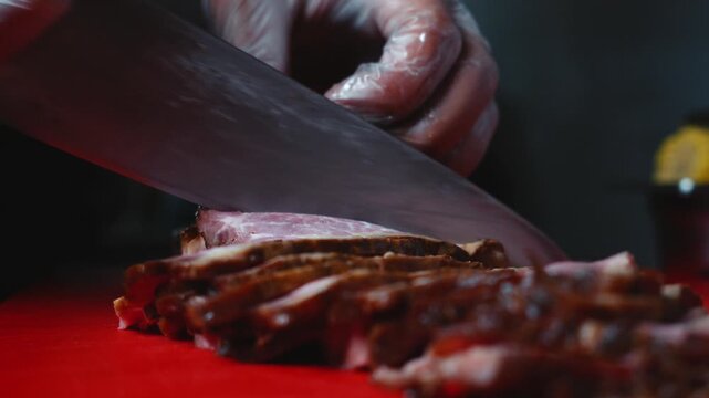 Slicing Meat with Large Kitchen Knife Close Up