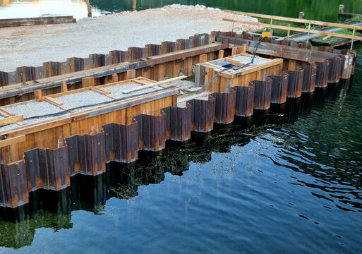 sheet pile cofferdam made of steel piles. Construction Detail Material structure consists of interlocking steel profiles known as Larssen sheet piles. These are driven deep into river 