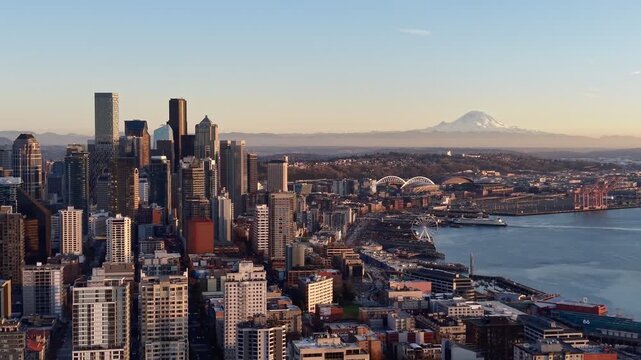 Seattle skyline and Elliott Bay with Mount Rainier at sunset, Washington, USA aerial view. g.