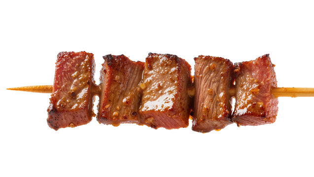 Isolated delicious savory grilled beef shish kebab cubes on a wooden skewer, perfectly cooked