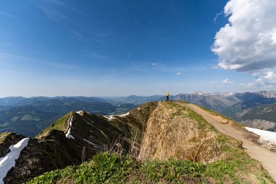 Hiker standing on scenic Fellhorn mountain ridge trail in Germany