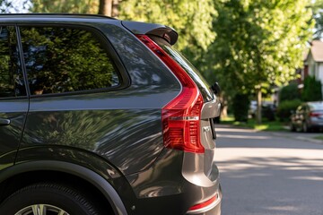 Fototapeta premium The SUV Rear View in Sunlit Suburban Street with Reflections