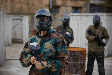 Fototapeta premium An armed group of several soldiers practice with weapons on a training field