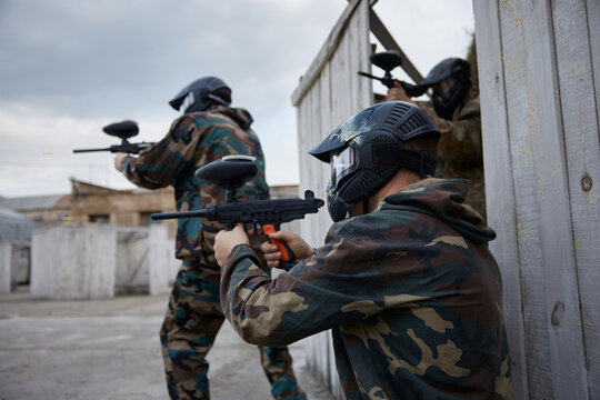 Two soldiers point their guns at a target on a training field