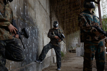Fototapeta premium An armed group of several soldiers resting from practice with weapons on a training field