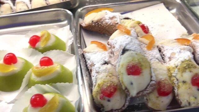 Tradition italian desserts as sicilian cannoli, sicilian cassata, typical fresh pastry at bakery shop bar,  Sicily, Italy