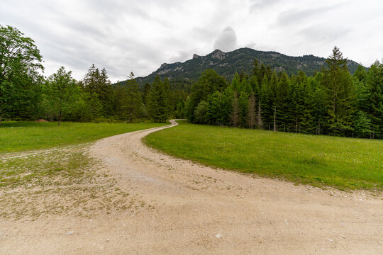 Winding dirt road through scenic alpine meadows in Mittenwald