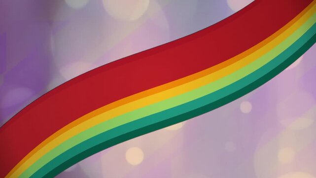 Wavy rainbow colored ribbon moving across a soft purple bokeh background