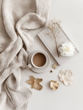 Cozy autumn flat lay with coffee cup and knitted blanket