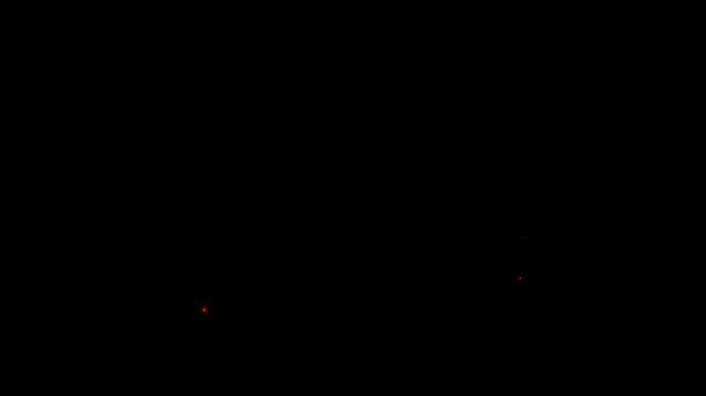 Abstract red light particles explosion. Glowing energy burst on a dark black background.