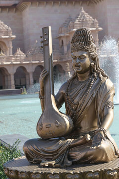 Divine melody resonates through the serene grounds of a traditional Hindu temple complex.