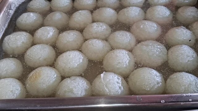 Traditional Spongy White Rasgulla Sweet Soaked in Sugar Syrup