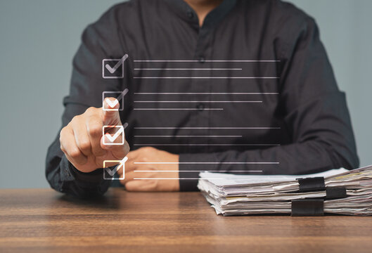 Businessperson Using Virtual Checklist at Office Desk