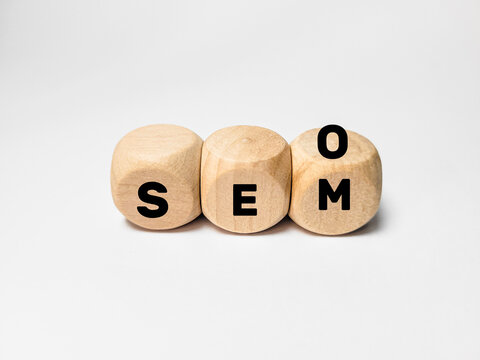 SEO and SEM Marketing Concept Written on Wooden Blocks Over White Background

