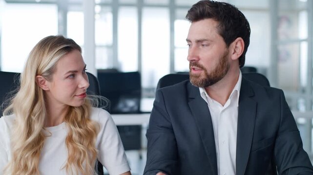 Two business coworkers discussing job brainstorm talking about work decision at conference meeting at office Caucasian businessman talk with businesswoman indoors working man with woman communicate