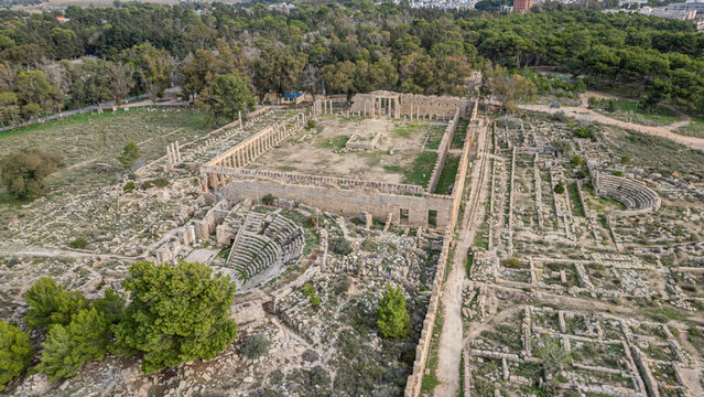 Aerial view shows ruins of Cyrene site in eastern Libya with ancient structures and green surroundings