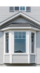 Obraz premium A classic white bay window architectural feature on a residential home exterior with clean gray vinyl siding and bright daytime lighting, home, neighborhood, trim