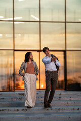 Business professionals communicating on steps at sunset © Zoran Jesic