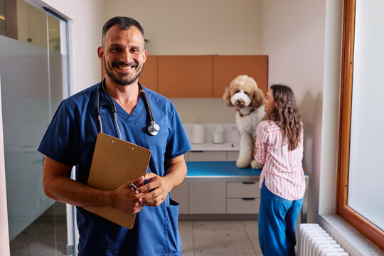 Veterinarian smiling holding clipboard standing in vet clinic