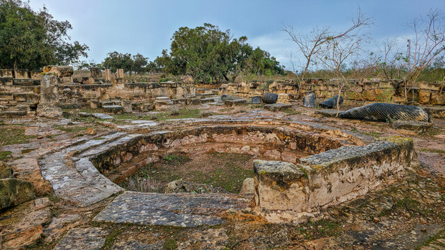 Exploring the ancient ruins of Ptolemais in Eastern Libya with its circular stone structure and scattered remains