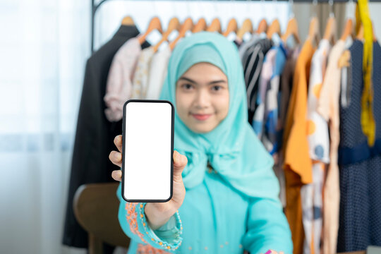 Close-up of a person holding a mobile phone with an empty screen, perfect for application display, advertisement design, and template mockup.