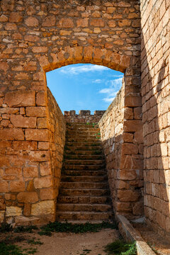 Exploring the stone archway and steps of an old fort in Qasr Libya with background of blue sky in Eastern Libya