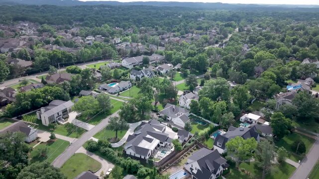 Upscale homes, lush green lawns, and tree-lined streets in Nashville&rsquo;s exclusive Green Hills neighborhood, a luxury real estate suburb in Tennessee - aerial flyover