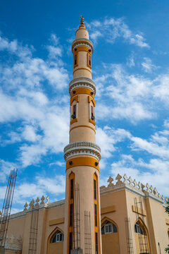 Mosque structure with a tall minaret under blue sky in Port Sudan, Sudan
