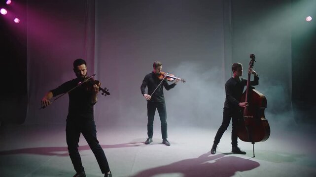 Drawing bow left violinist starting trio playing violins and bass in studio, wearing dark clothes