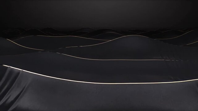 Moving camera revealing glossy black sheet forms undulating on dark studio highlighting gold edges