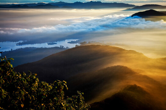 Sunrise view from Sri Pada reveals layers of mountains and mist over the landscape in Sri Lanka