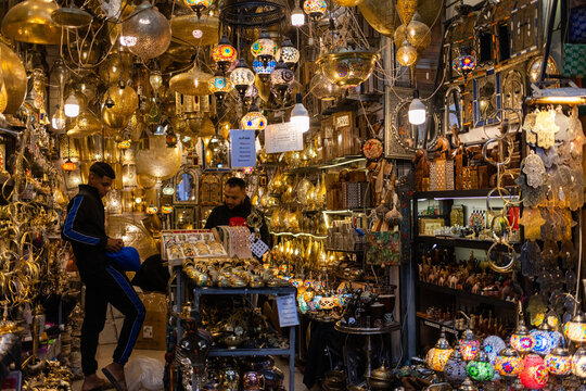 Locals and tourists explore shops filled with crafts and lights in Marrakesh old medina on December 4, 2025