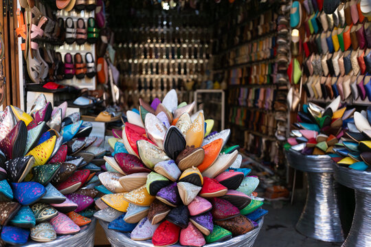 Colorful souvenirs and spices displayed at market in old Medina during daytime in Marrakesh, Morocco
