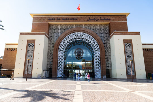 Train station in Marrakesh shows modern architecture and people arriving and leaving