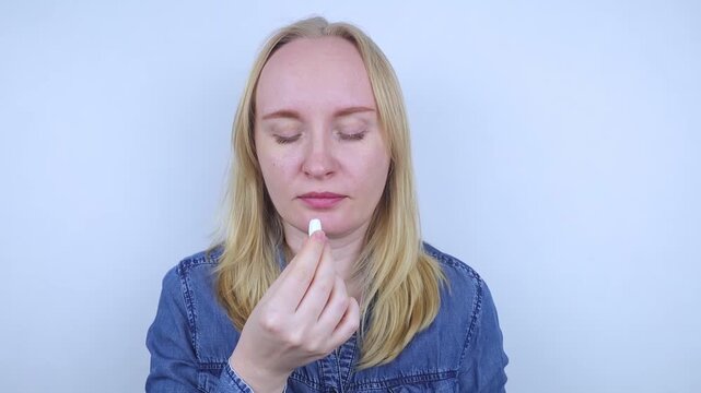 Woman suffering from phagophobia struggling to swallow a pill. Anxious female holding a medicine bottle, feeling fear, stress and difficulty swallowing medication.