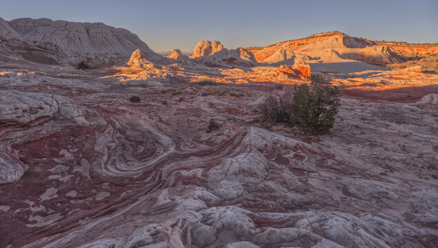 Colorful sandstone formations display unique textures and patterns on the Paria Plateau in Arizona during evening light